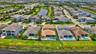 Aerial perspective showcasing multiple properties with private swimming pools and manicured green spaces