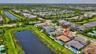 Aerial perspective showcasing a modern residential neighborhood with multiple water features