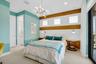 Bedroom featuring a contemporary chandelier, built-in textured wall paneling, and wood-finish accent strips