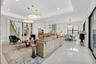 Spacious open-concept living area featuring high ceilings with recessed lighting, large format polished tile flooring, and a contemporary staircase wi