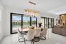 Spacious interior featuring white tile flooring and a decorative chandelier