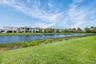 Expansive green lawn bordering a tranquil water feature