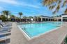 Expansive outdoor swimming pool with integrated steps and metal handrails