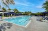 Expansive outdoor swimming pool with lane markers, integrated entry steps, and surrounding paver decking