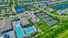 Community hub featuring multiple swimming pools, extensive tennis courts, and recreational fields