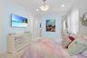 Interior room featuring light blue walls with white trim and carpeting