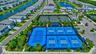 Recreational amenities featuring multiple hard-surface sports courts, including blue and green courts with perimeter fencing and lighting