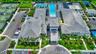 Community amenities featuring a large central building with multiple gabled roofs, an expansive swimming pool area, multiple tennis courts, and dedica