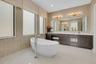 Freestanding soaking tub with floor-mounted chrome faucet