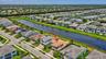 Aerial view of a residential community with a central waterway