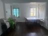 Hardwood flooring, painted white walls, white window trim, and a coffered ceiling