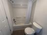 White tub and shower combination with chrome fixtures