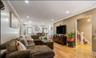 Recessed lighting, crown molding, wood-finish flooring, and a built-in entertainment console
