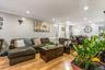 This spacious living room features bright hardwood floors and a massive open layout that flows seamlessly into the dining area. Recessed ceiling light