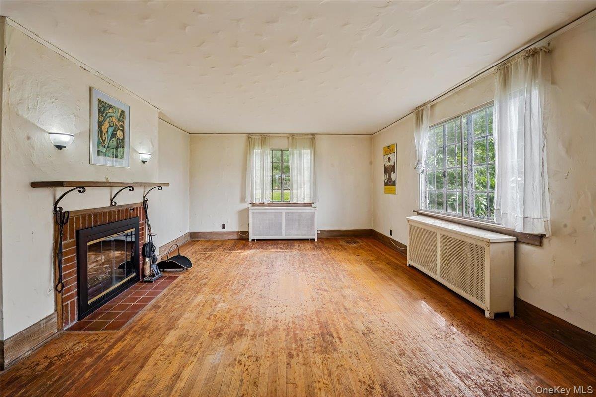 Living Room with wood burning fireplace and hardwood floors