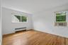 Primary bedroom with windows for natural light