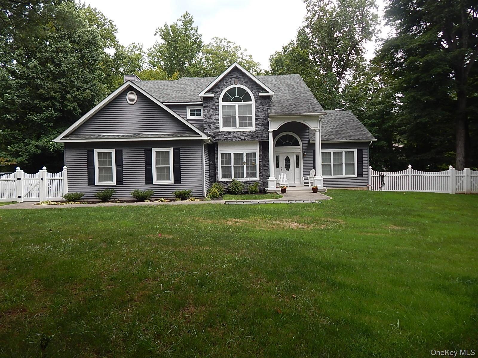 Charming, modern colonial features natural setting and all the conveniences.