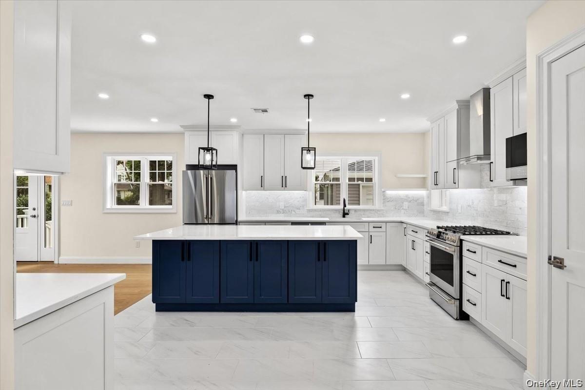 Bright formal dining area and kitchen transition layout, featuring premium quartz counters and open space with optional builder customization for arch