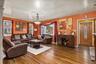 Hardwood flooring, decorative front entry door with leaded glass insert, multiple windows with natural light, ceiling medallion with attached lighting