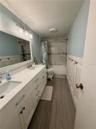 Upstairs bathroom with double sinks and lots of storage! Gorgeous tile in the bathtub and beautiful wood-look ceramic tile