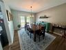 Large dining room accommodates plenty of furniture and French Doors lead to the paver patio