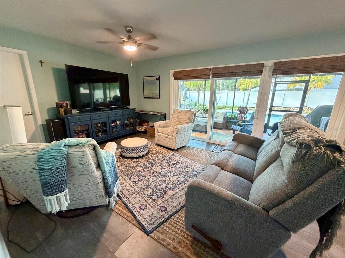 Versatile family room overlooking the patio and pool