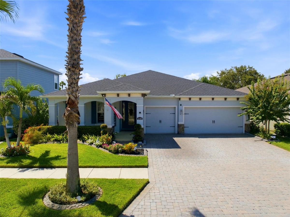 Original-owner home with a 3-car garage, paver driveway and thoughtfully upgraded landscaping.