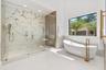 10 ft shower with dual rainfosrest starions and bookend matched porcelain wall accent. Soaking tub and heated towel rack