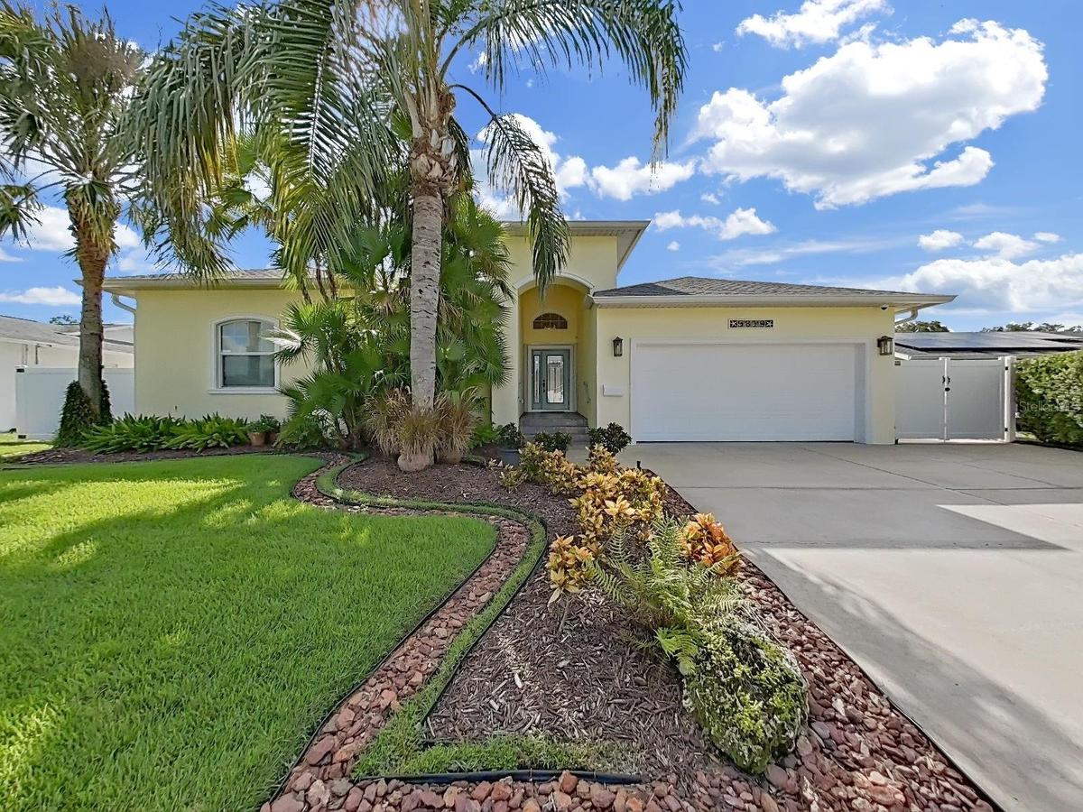 Meticulously cared for and beautifully landscaped with mature palm trees and garden beds. The large driveway and arched entryway welcome you home.
