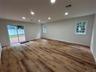 Den with new: sliding glass doors, recessed lighting and flooring
