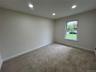 Bedroom with recessed lighting and new carpeting