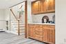 Stairs to lower finished living space.  Wet Bar , full bath and more.