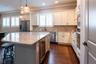 Wine refrigerator and a pantry closet.