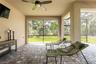 Large lanai for enjoying the outdoors with no rear neighbors and artificial turf in the backyard.