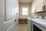 Spacious laundry room with storage and a folding shelf.