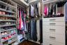 Spacious customized closet with soft close drawers.