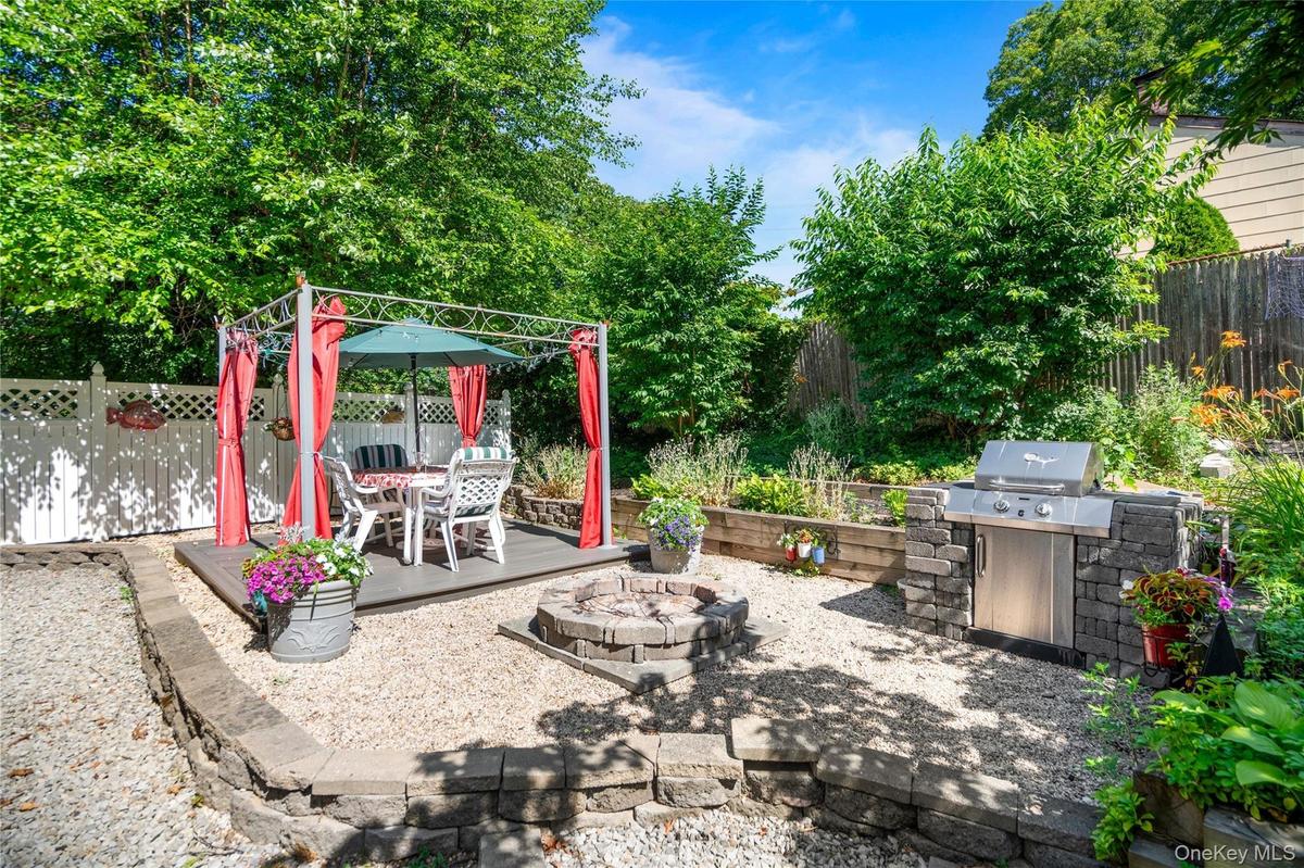 12' x 12' platform structure featuring a stone built-in BBQ and a custom fire pit.