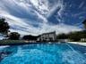 Fenced backyard with in-ground swimming pool.