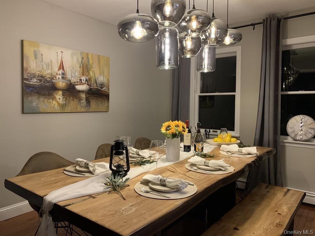 Dining area with a wood-finish dining table with a live edge and coordinating bench seating