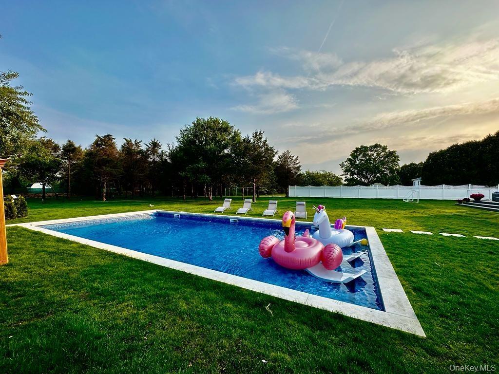 Heated in-ground swimming pool with a tile surround