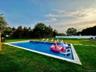 Heated in-ground swimming pool with a tile surround