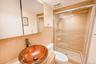 Glass-enclosed shower with tiled walls and decorative accent band