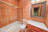 Bathroom featuring a shower/tub combination with glass enclosure, a vanity with an integrated sink and countertop, and a toilet