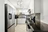 Kitchen - Washer and dryer plug ins available underneath counter across from fridge
