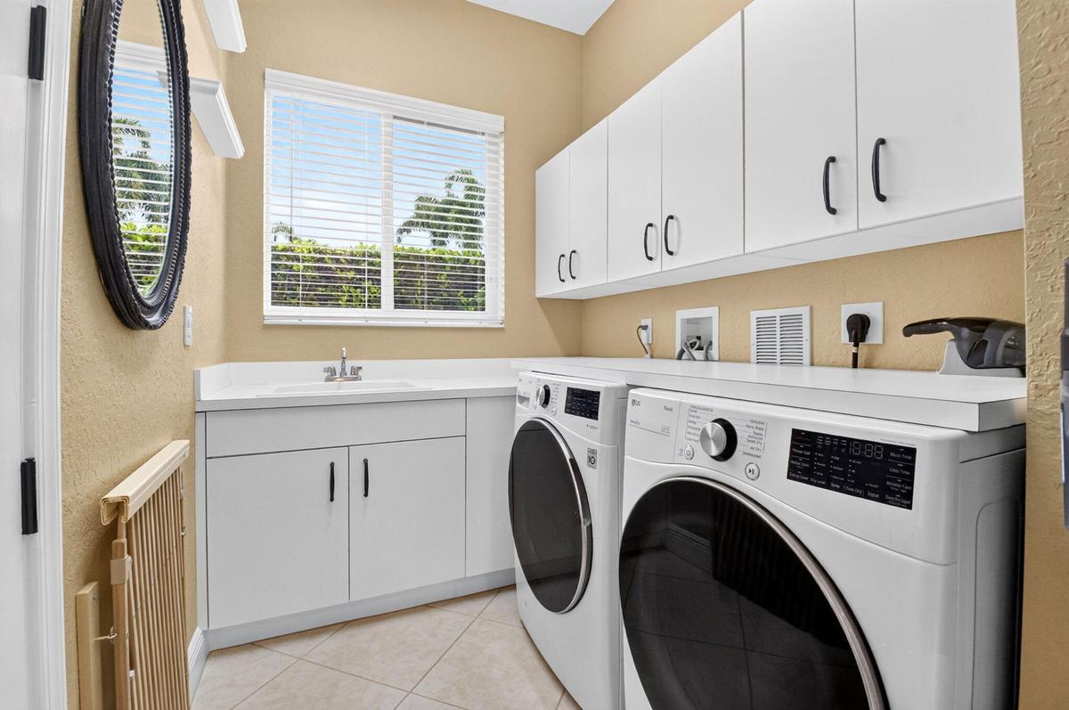White cabinetry, integrated sink, and ample countertop space