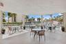 The community café/restaurant offers outdoor seating framed by views of the swimming pool.