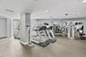 The on-site fitness center includes cardio and strength-training equipment for resident use.