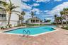 The heated community pool is surrounded by a broad deck, palm landscaping and convenient pavilion space.