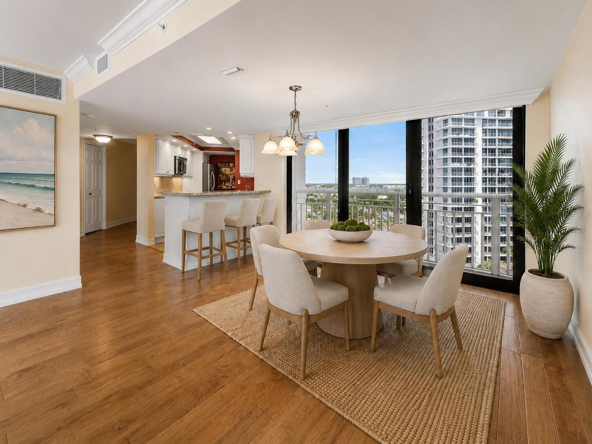 Virtually staged; residence is offered unfurnished. The dining area connects naturally with the kitchen and surrounding living space for an open, flex