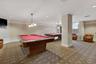 The billiard room offers two pool tables along with lounge seating for recreation and socializing.